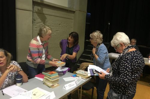 Members at registration around the world literature table.